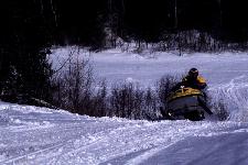 A snowmobile on a snowy trail